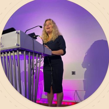 Elle McDonald delivering a keynote on stage
